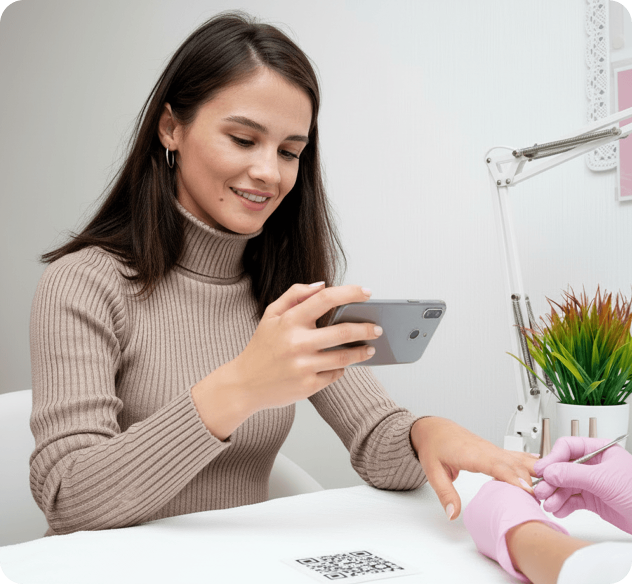 Customer using phone with QR code at cafe
